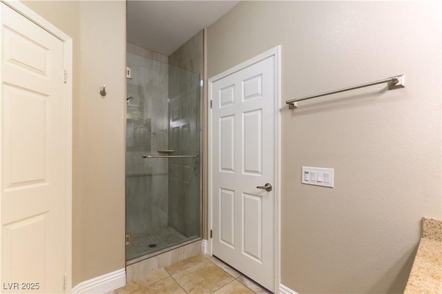 bathroom with tile patterned floors and a shower with shower door