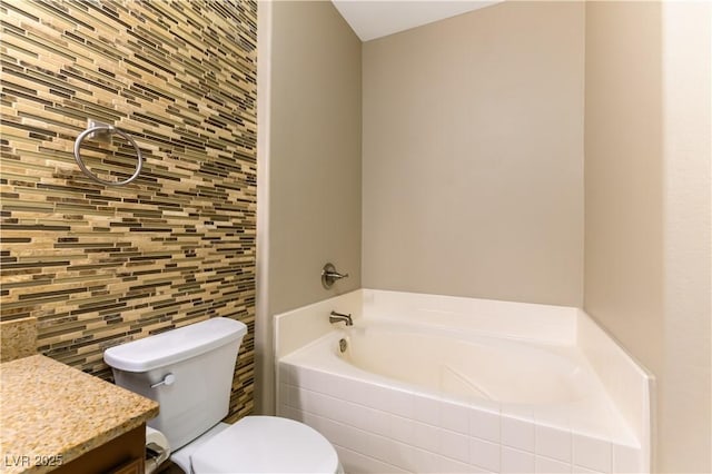 bathroom with vanity, toilet, decorative backsplash, and a washtub