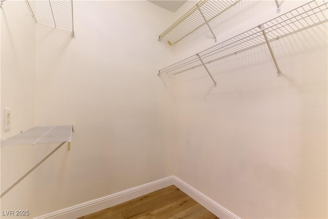 spacious closet featuring hardwood / wood-style flooring