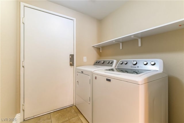 laundry room featuring washing machine and clothes dryer and light tile patterned flooring