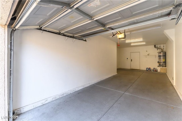 garage with a garage door opener and secured water heater