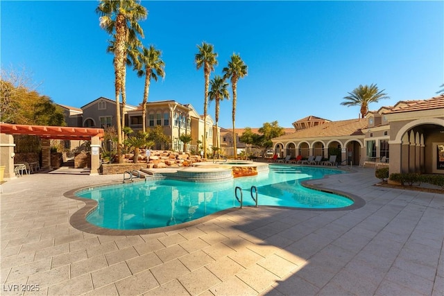 view of swimming pool featuring a patio, a pergola, and a community hot tub