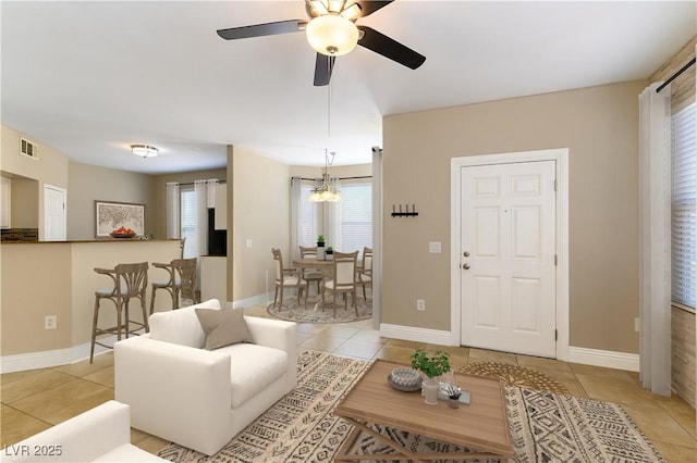 tiled living room with ceiling fan