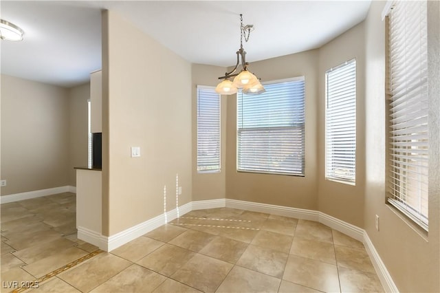 unfurnished dining area featuring light tile patterned flooring