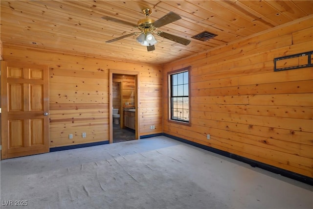 empty room featuring wooden walls, wooden ceiling, and ceiling fan