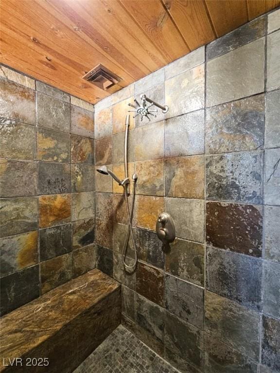 bathroom with tiled shower and wooden ceiling