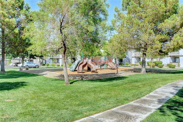 surrounding community with a yard and a playground