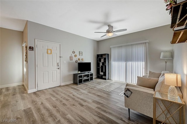 living room with light hardwood / wood-style floors and ceiling fan