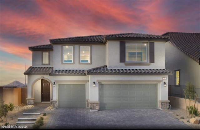 mediterranean / spanish-style house featuring a garage