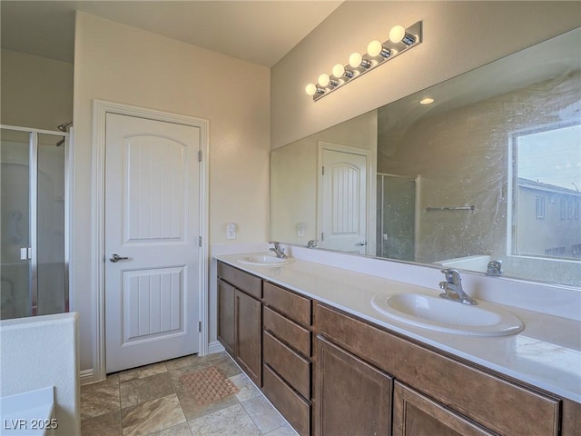 bathroom with walk in shower and vanity