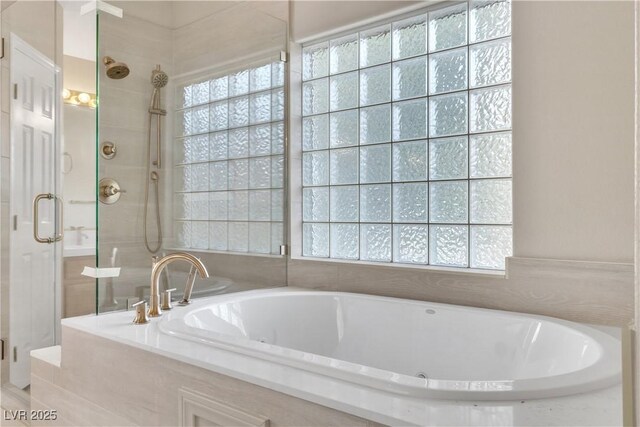 bathroom featuring separate shower and tub and a wealth of natural light