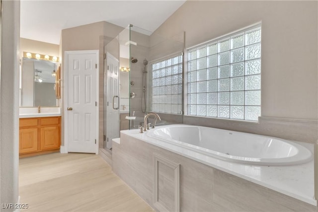 bathroom with vanity, shower with separate bathtub, and wood-type flooring