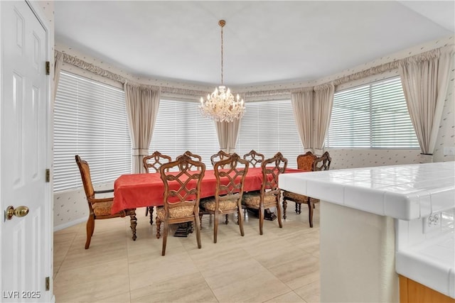 dining area with light tile patterned floors and a chandelier