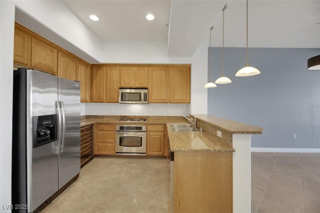 kitchen featuring appliances with stainless steel finishes, decorative light fixtures, sink, light stone counters, and kitchen peninsula