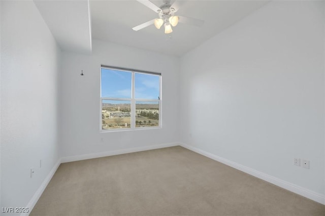 empty room with light colored carpet and ceiling fan