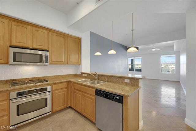 kitchen with sink, appliances with stainless steel finishes, backsplash, decorative light fixtures, and kitchen peninsula