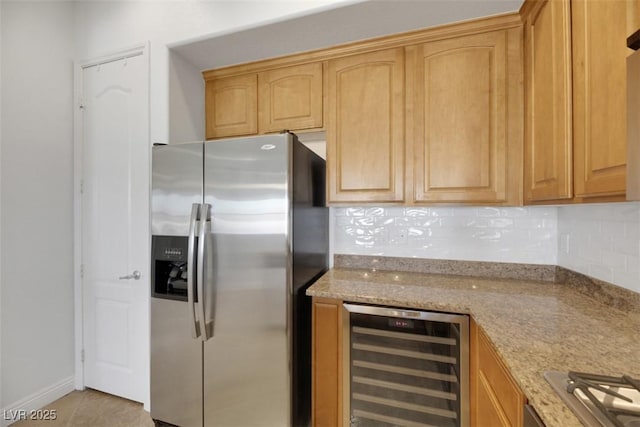 kitchen featuring wine cooler, light tile patterned flooring, tasteful backsplash, light stone counters, and stainless steel appliances