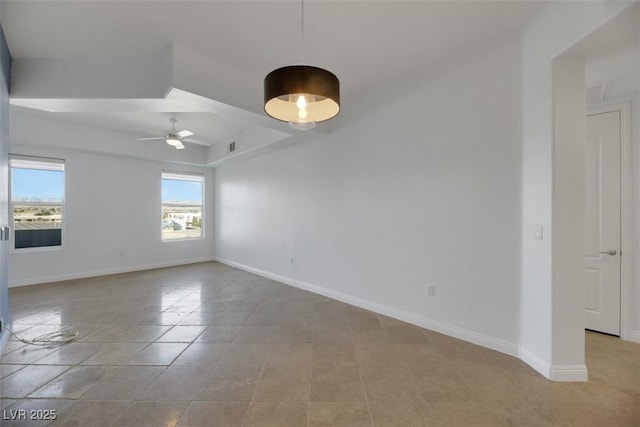 tiled spare room featuring ceiling fan