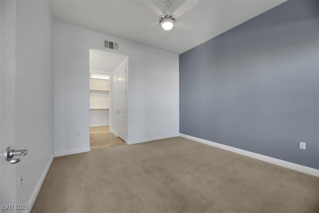 unfurnished room featuring light colored carpet and ceiling fan