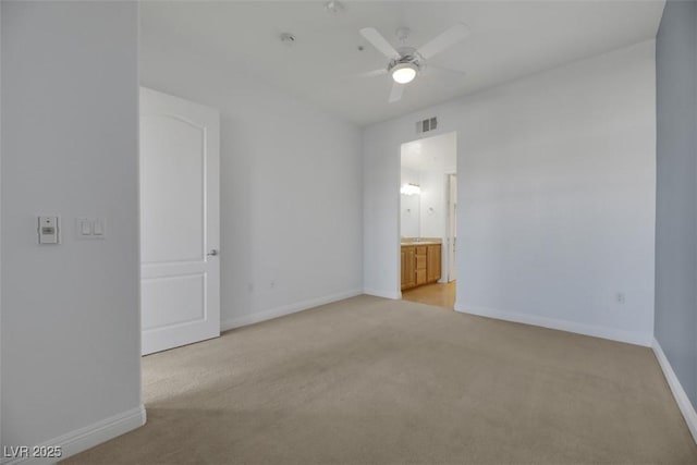 unfurnished room with ceiling fan and light carpet