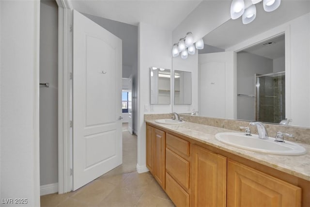 bathroom featuring vanity, an enclosed shower, and tile patterned floors