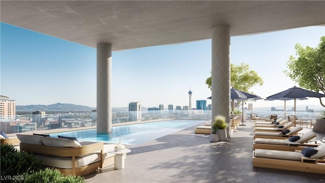 view of pool featuring a mountain view and a patio