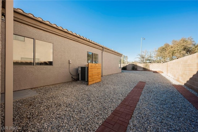 view of yard with a patio area and central air condition unit