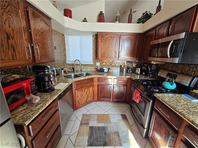 kitchen featuring stainless steel appliances, sink, and decorative backsplash