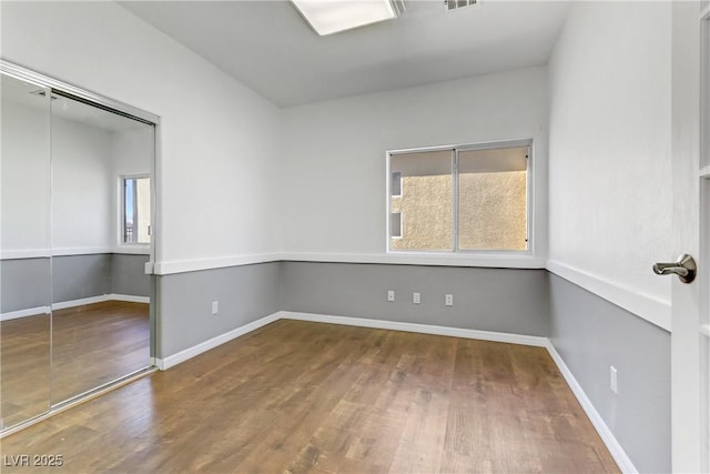 empty room with wood-type flooring