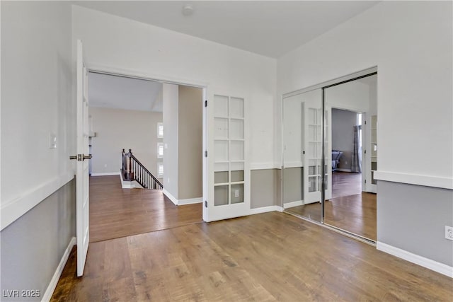 empty room featuring wood-type flooring and french doors