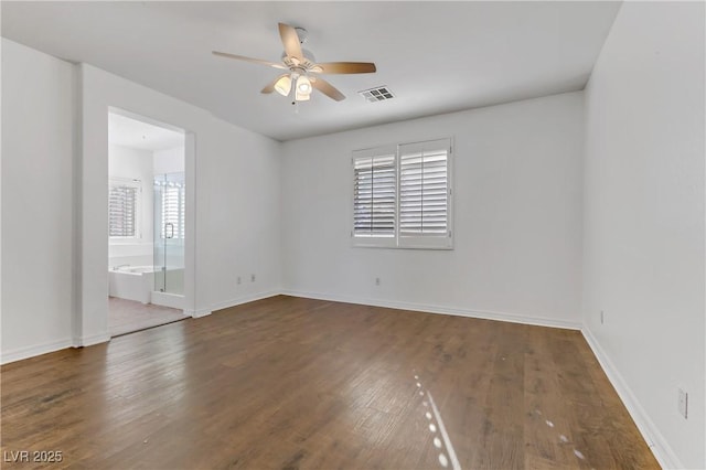 spare room with dark hardwood / wood-style flooring and ceiling fan