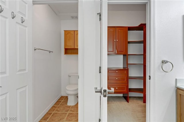 bathroom featuring tile patterned floors, toilet, and vanity