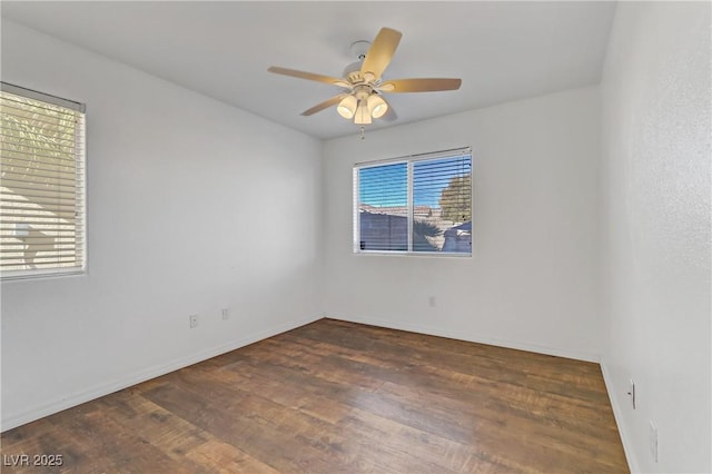 unfurnished room with ceiling fan, plenty of natural light, and dark hardwood / wood-style flooring