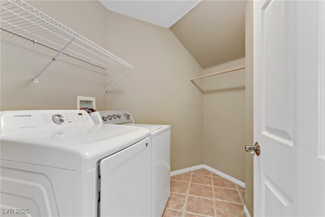 clothes washing area with separate washer and dryer and light tile patterned floors