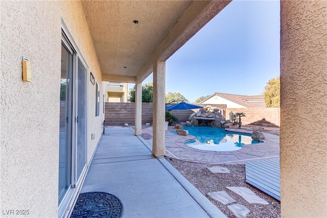 view of patio with a fenced in pool