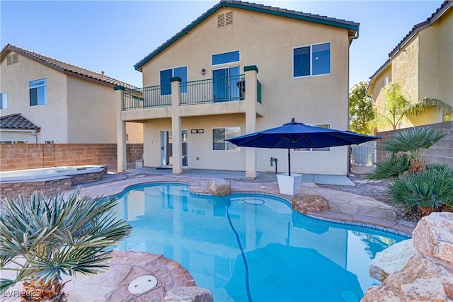 view of swimming pool featuring a patio and an in ground hot tub