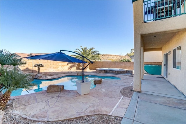 view of swimming pool with a patio and an in ground hot tub