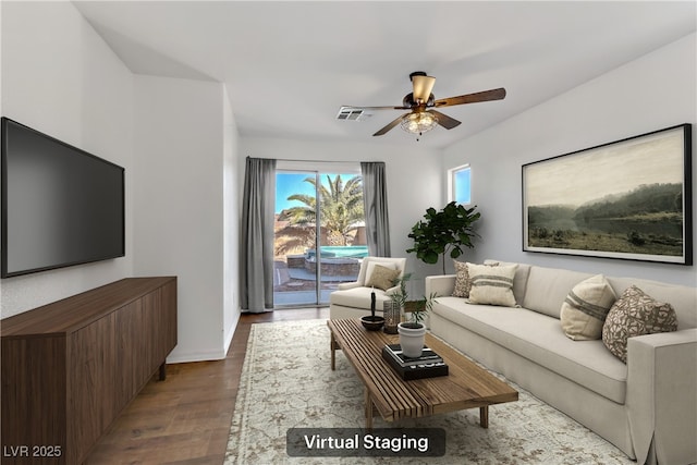 living room featuring hardwood / wood-style floors and ceiling fan