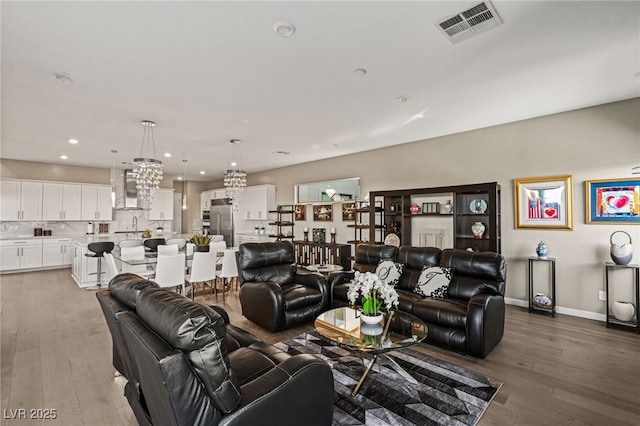 living room featuring sink and hardwood / wood-style floors