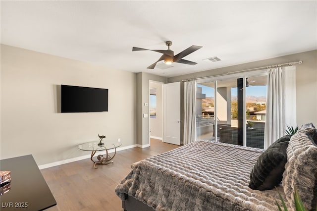 bedroom featuring dark hardwood / wood-style flooring, access to exterior, and ceiling fan