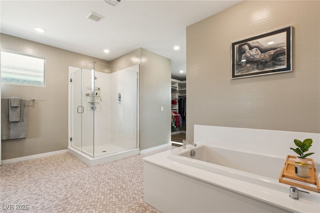 bathroom featuring shower with separate bathtub