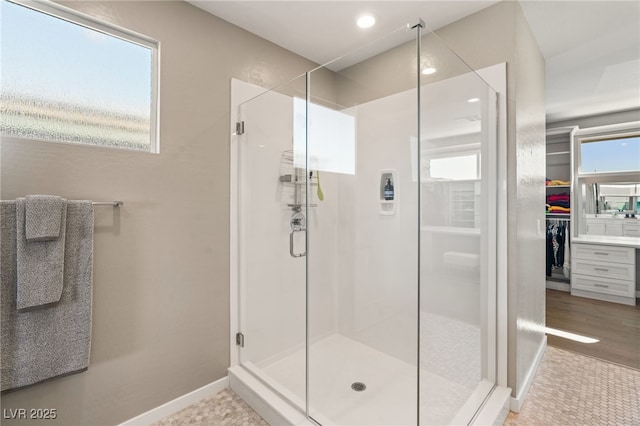 bathroom featuring a wealth of natural light and a shower with shower door