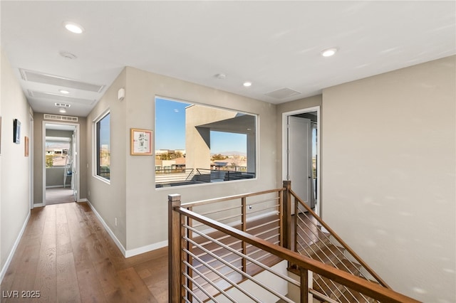 corridor with hardwood / wood-style flooring