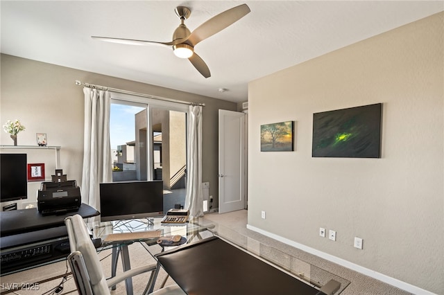 carpeted home office with ceiling fan