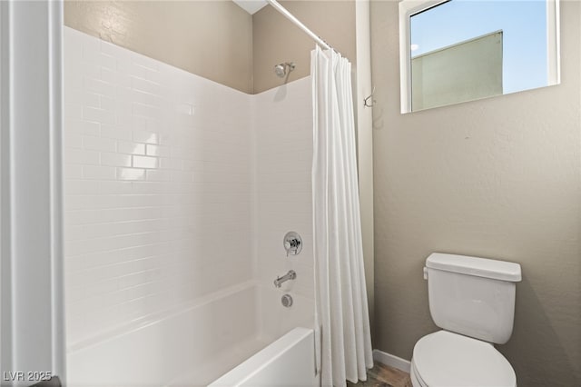 bathroom with shower / tub combo and toilet