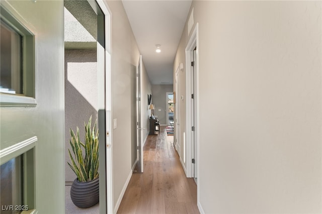 hallway with light hardwood / wood-style flooring