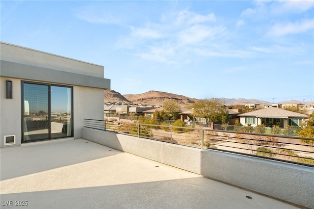 view of patio / terrace with a balcony and a mountain view