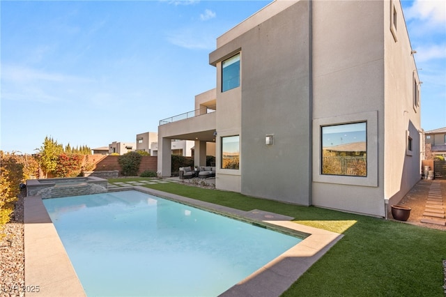 view of pool with an in ground hot tub and a lawn