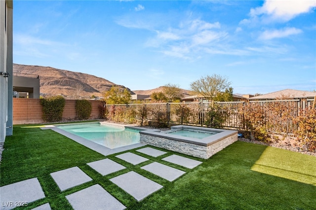 view of pool with a mountain view, a yard, and an in ground hot tub