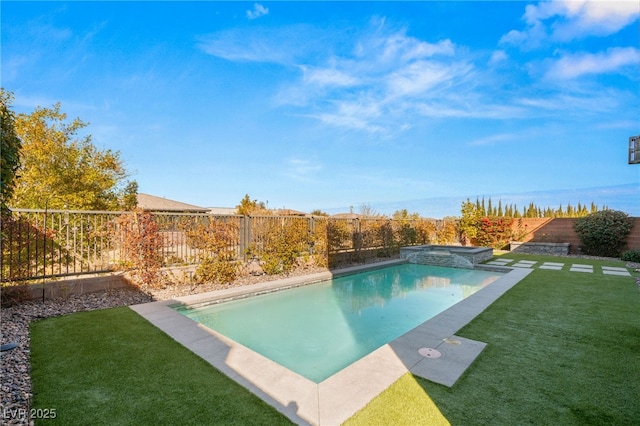 view of swimming pool featuring a lawn and an in ground hot tub